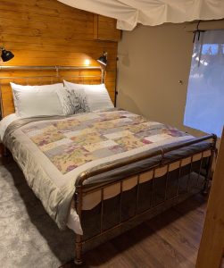 Cosy kingsize bed in luxury safari tent
