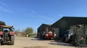 Two farm barns and a tractor