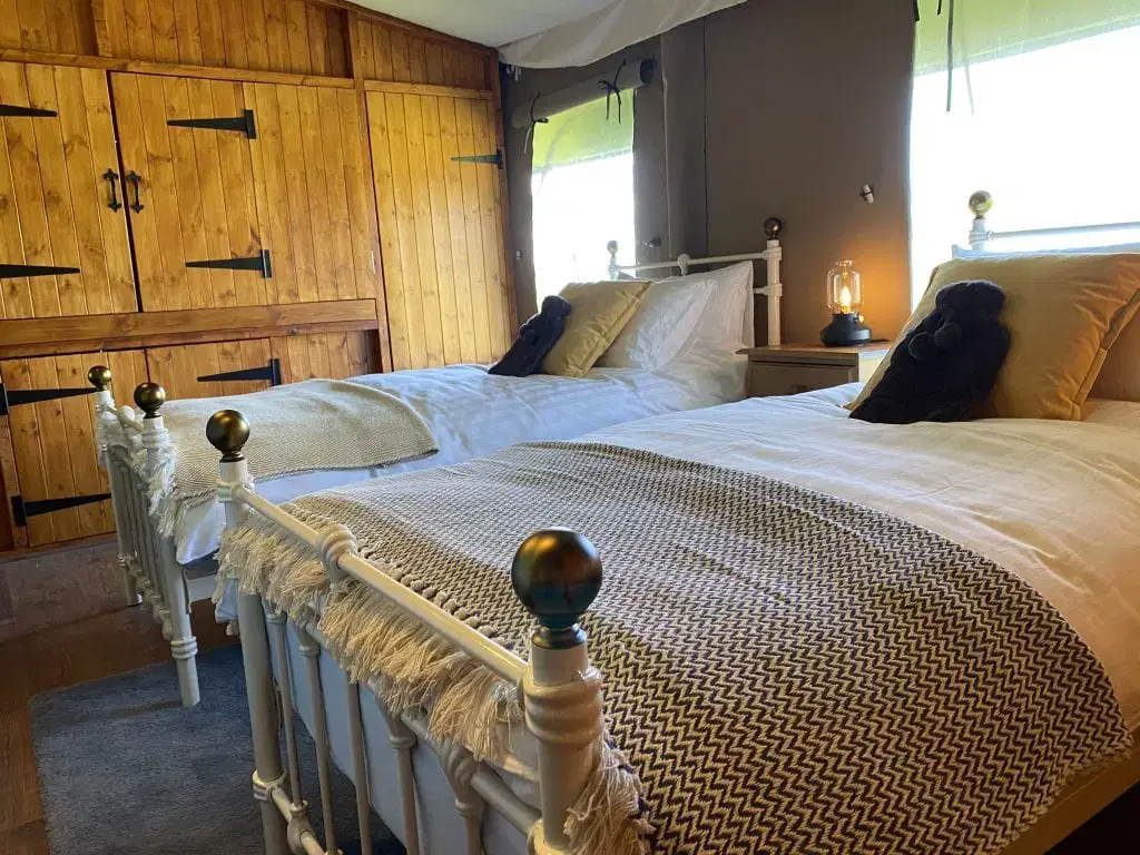 Two twin beds with a warm table light