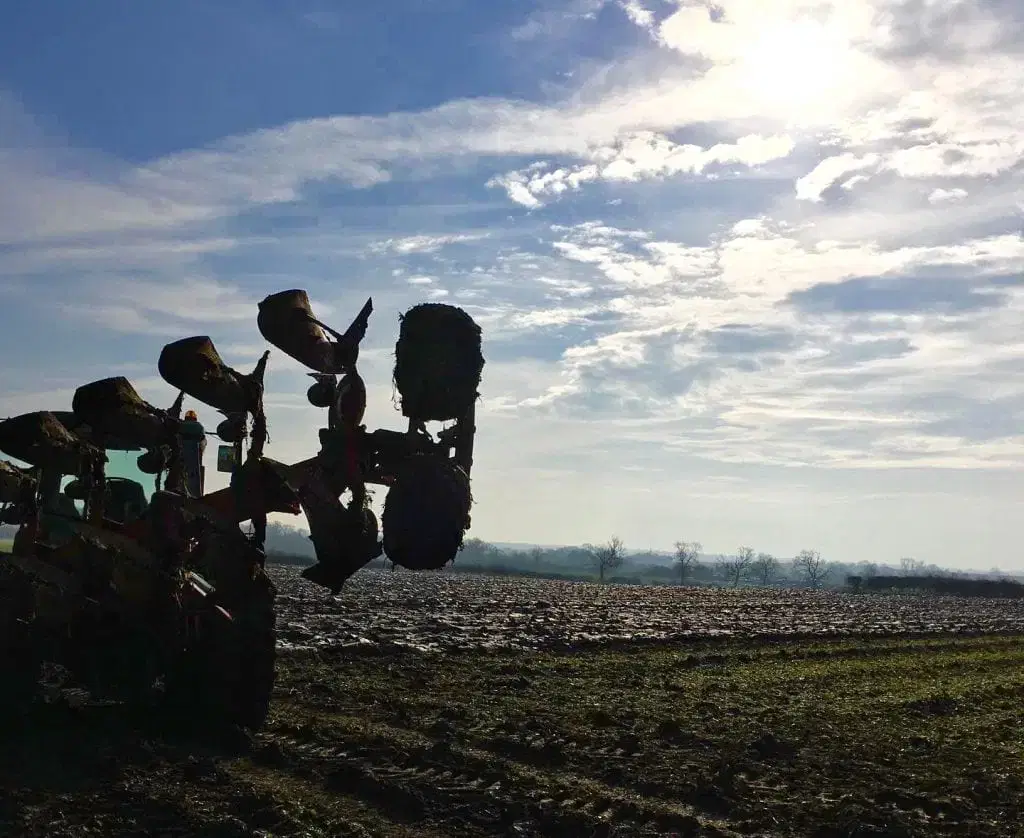 Farm machinery in a ploughed field