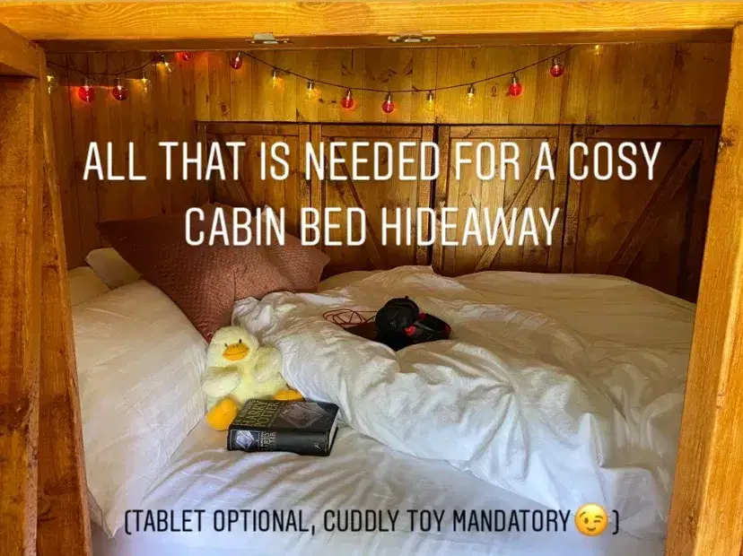 Cosy wooden cabin bed with cuddly toy and book