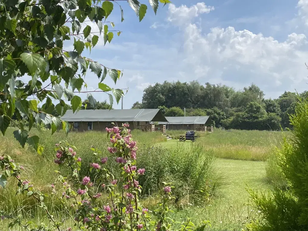 Luxury safari tent exterior at Meadow Field Glamping in the Warwickshire countryside.