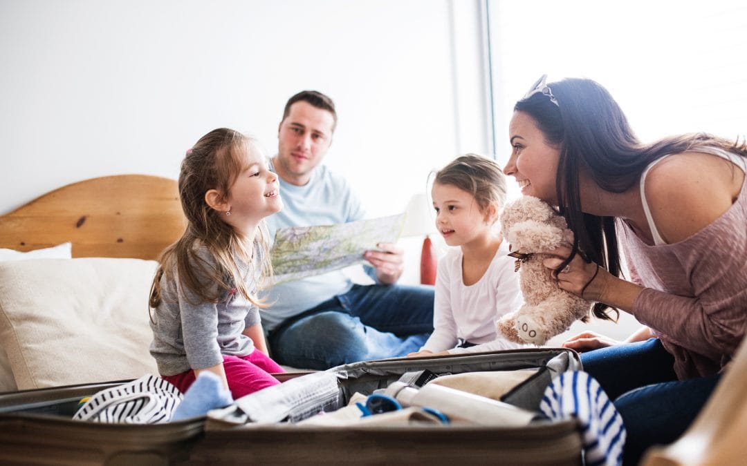 Young family with two children packing for holiday