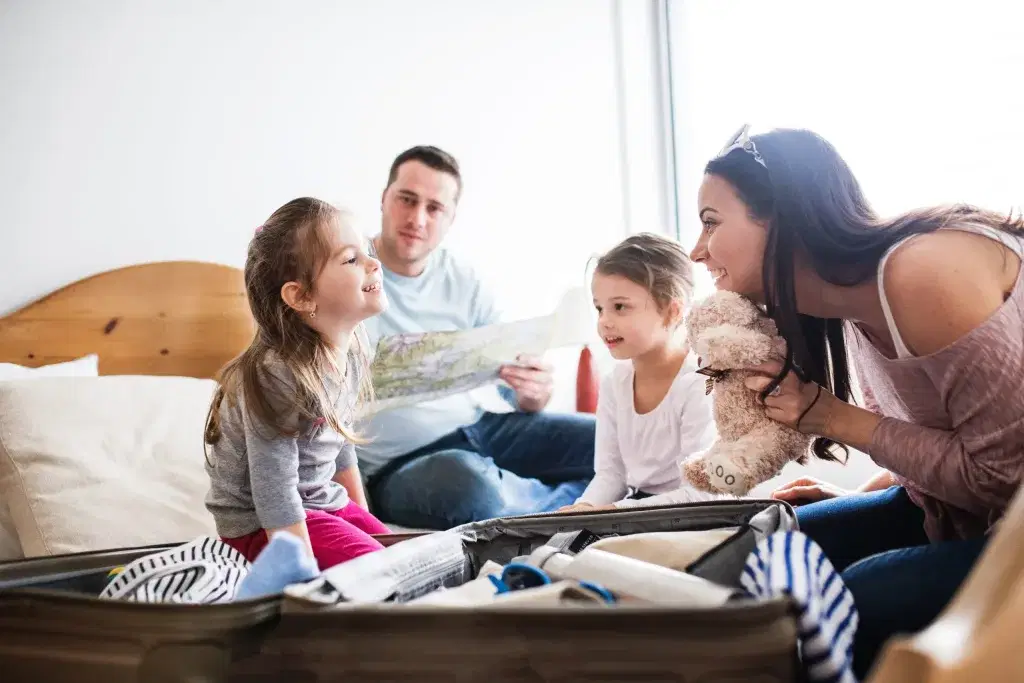 Young family with two children packing for holiday