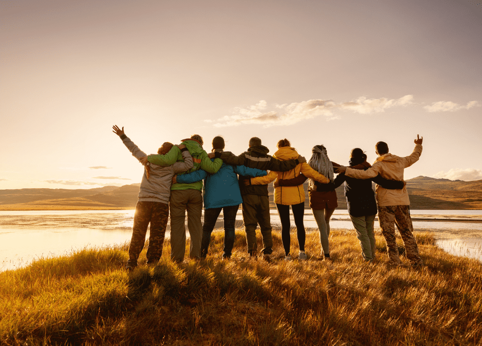 Friends gathered around a fire pit at Meadow Field, building the power of annual traditions