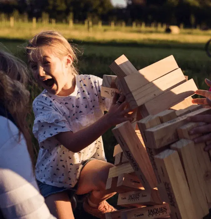 Children playing giant outdoor jenga